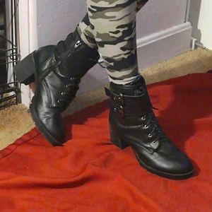 Black high healed leather double strapped combat boots.Size 9